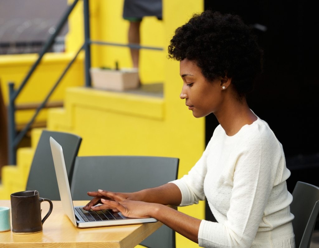 attractive-young-woman-using-laptop-outside-P9RLFGU@2x-1024x798-1.jpg